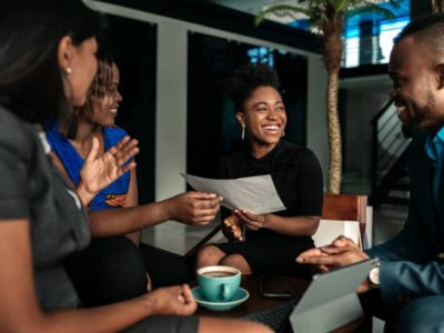 All african casual business meeting. Candid real happy moment between four work colleagues.